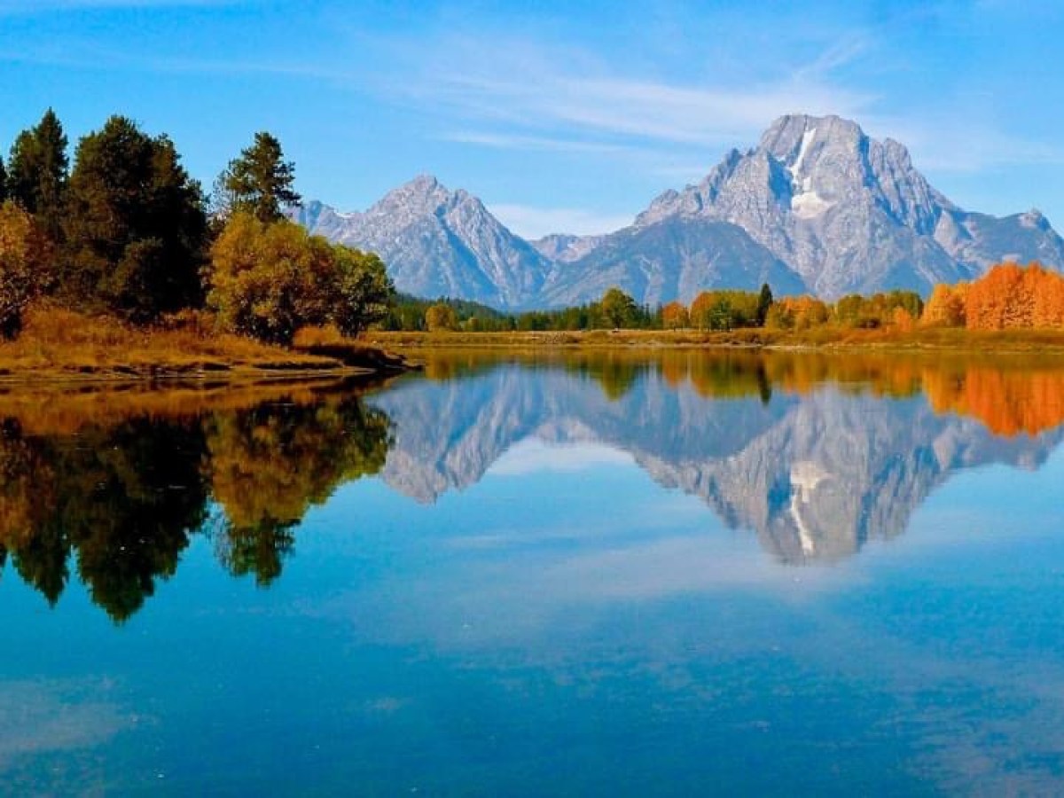 a body of water with a mountain in the background