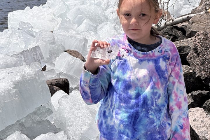 a little boy that is standing in the snow