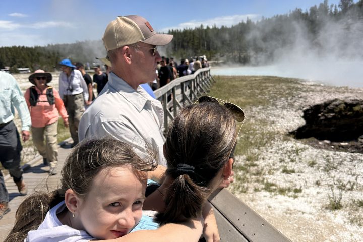 a group of people sitting at a beach