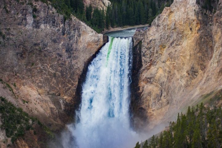 a waterfall with a mountain in the background