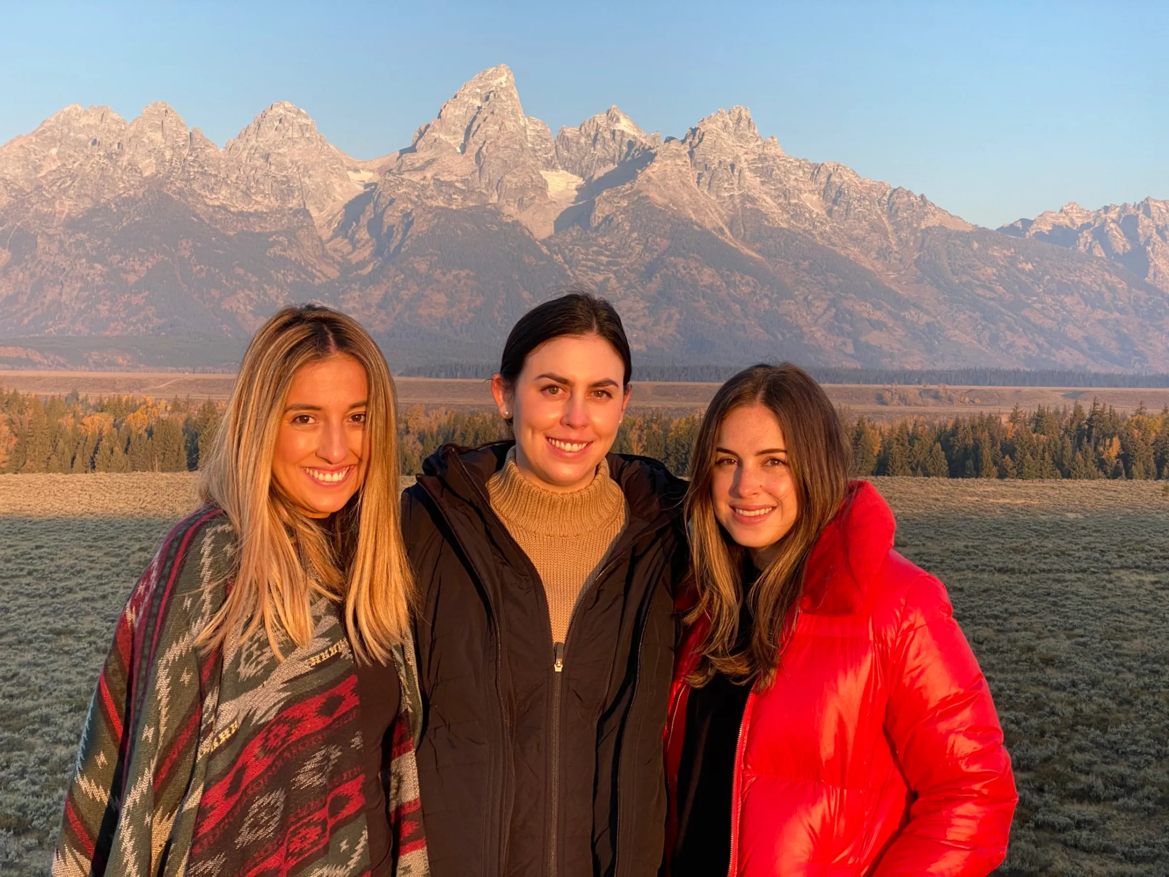 women standing in front of a mountain