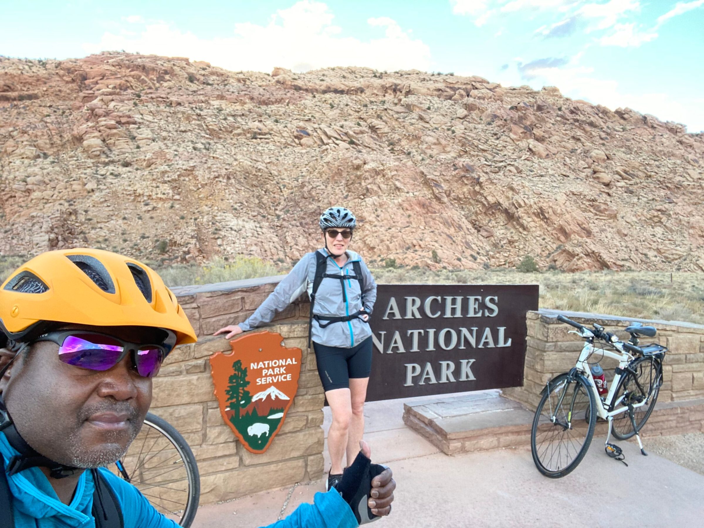 a man with a bicycle in front of a mountain