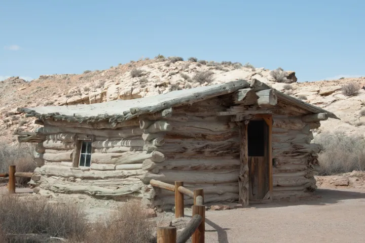 a stone building with a mountain in the background