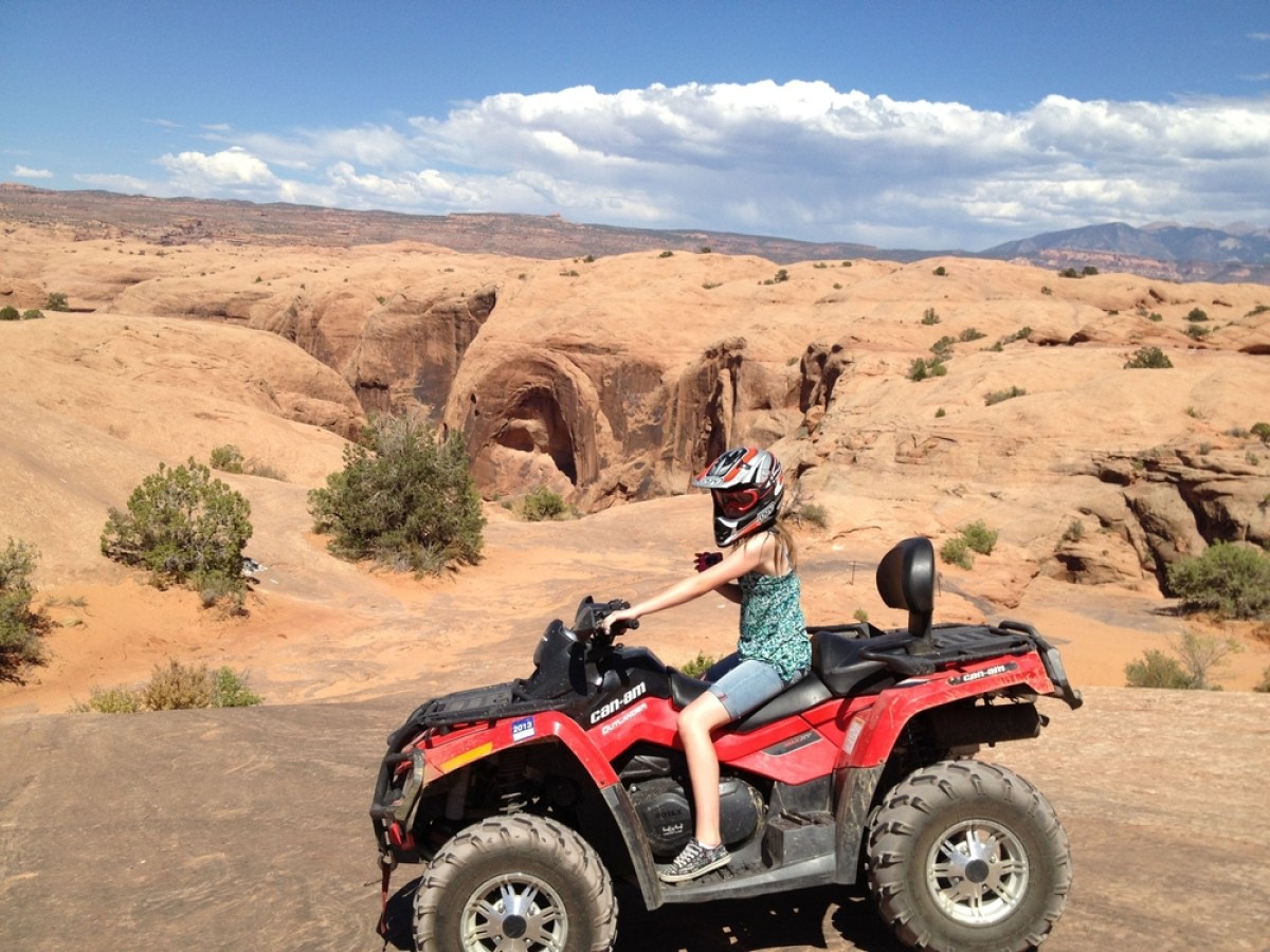 a motorcycle is parked on the side of a dirt road