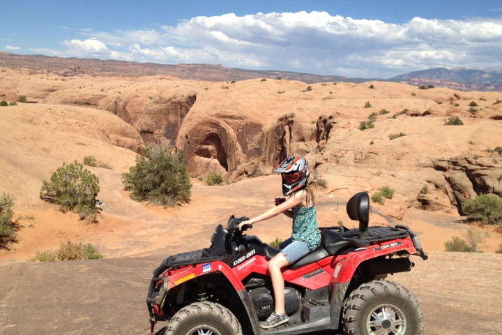 a motorcycle is parked on the side of a dirt road