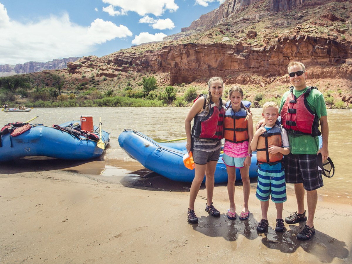 a group of people standing on a rocky beach