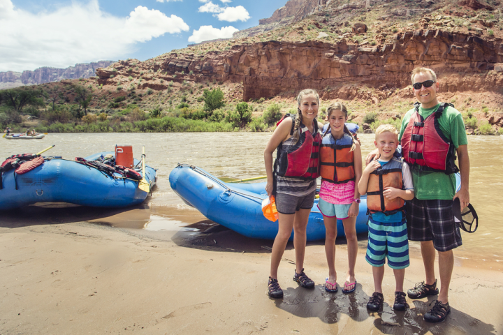 a group of people standing on a rocky beach