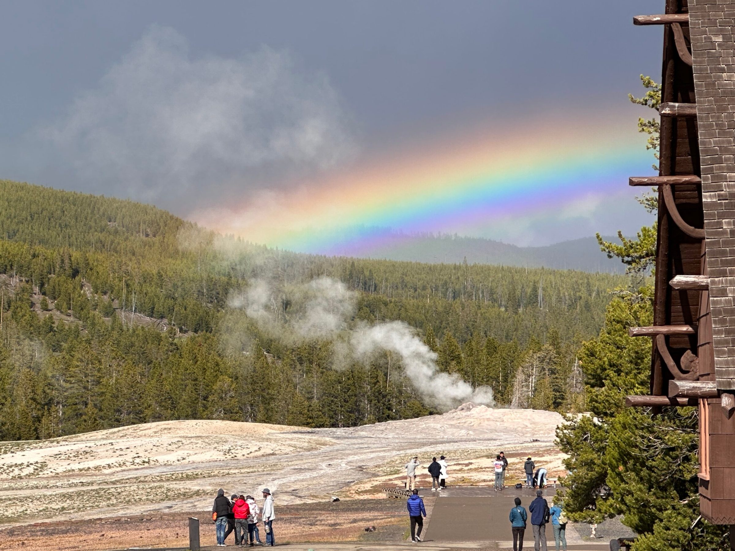 a group of people walking down a dirt road
