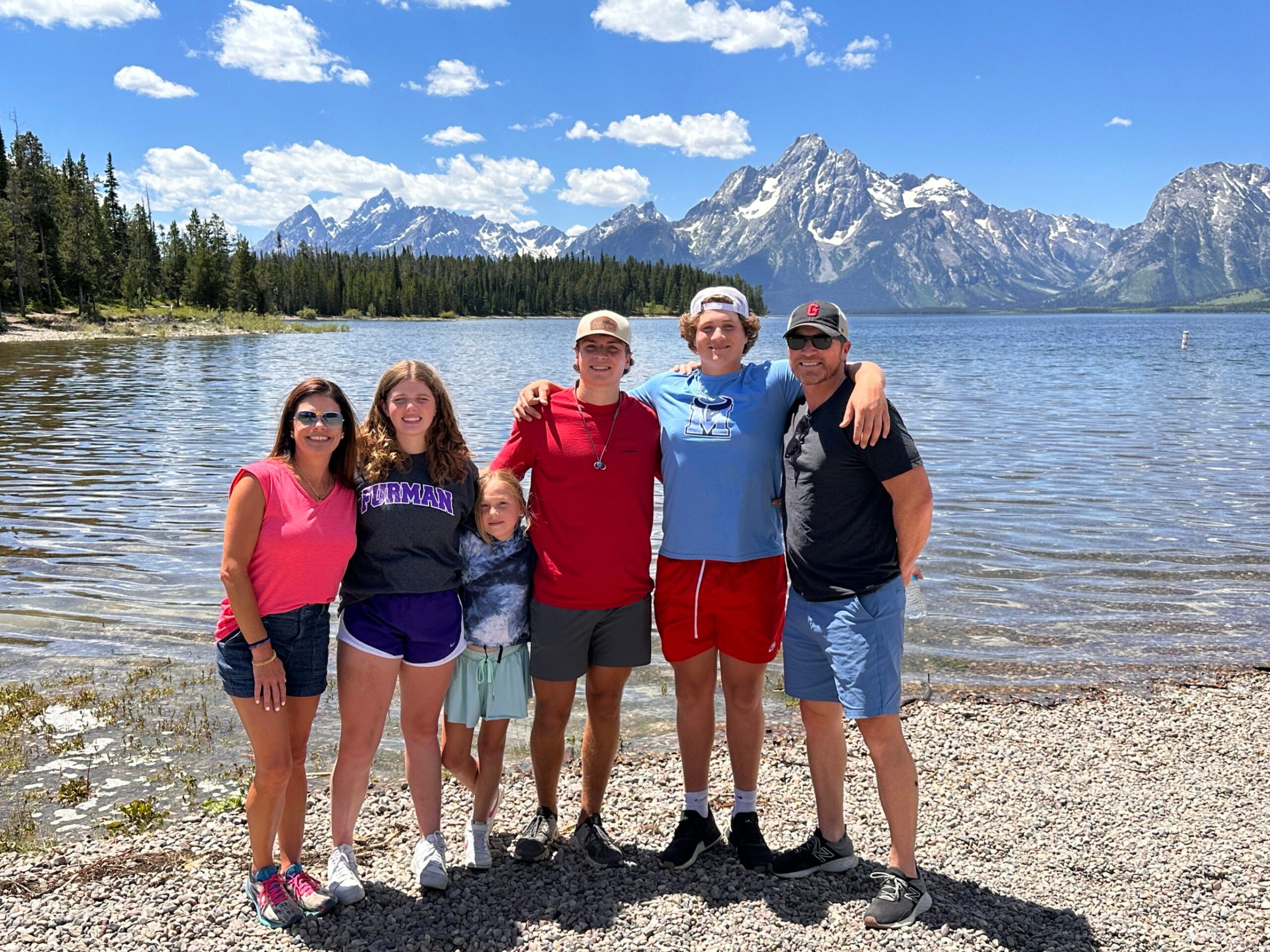 Family posing for a picture at Jackson Lake.