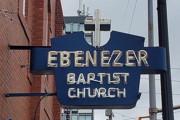 Blue sign reading 'Ebenezer Baptist Church' with a cross on top.