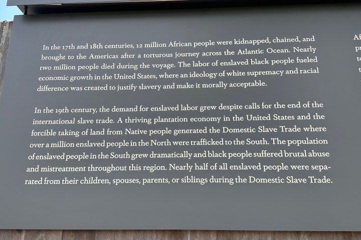 Informational board on the transatlantic slave trade and its impacts, highlighting African and Native peoples' suffering.