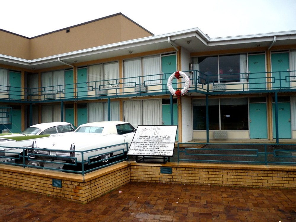 Lorraine Motel with vintage cars parked outside and memorial wreath on balcony