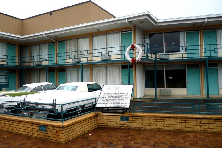 Lorraine Motel with vintage cars parked outside and memorial wreath on balcony